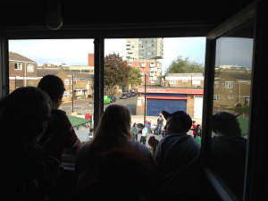 Campaigners look out onto the square from one of the reopened flats